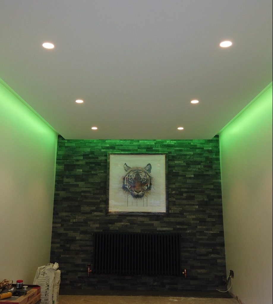 Splitface stone wall showcasing hidden colour change LED ceiling lighting and bezel-less downlights.